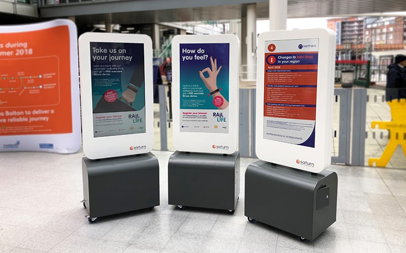 Mobile digital signage totems at a Manchester train station