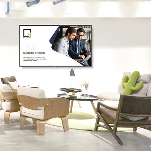 Corporate Digital Signage | An image of neutral-coloured office space with a large NEC digital signage screen on the wall.