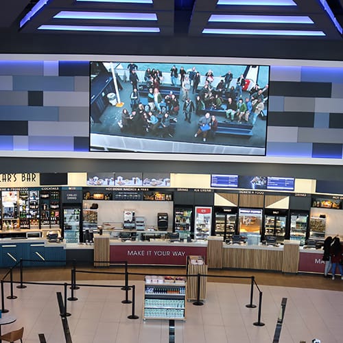 Menu boards and digital signage screen in a cinema foyer