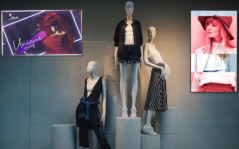 NEC high bright digital signage screens in the window of a clothing retail store