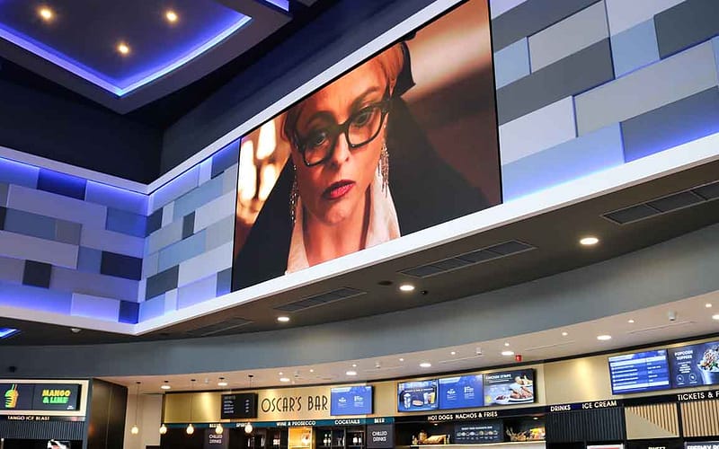 Large format digital signage screen in a cinema showing trailers