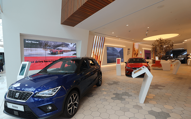Seat car showroom with multiple types of digital signage