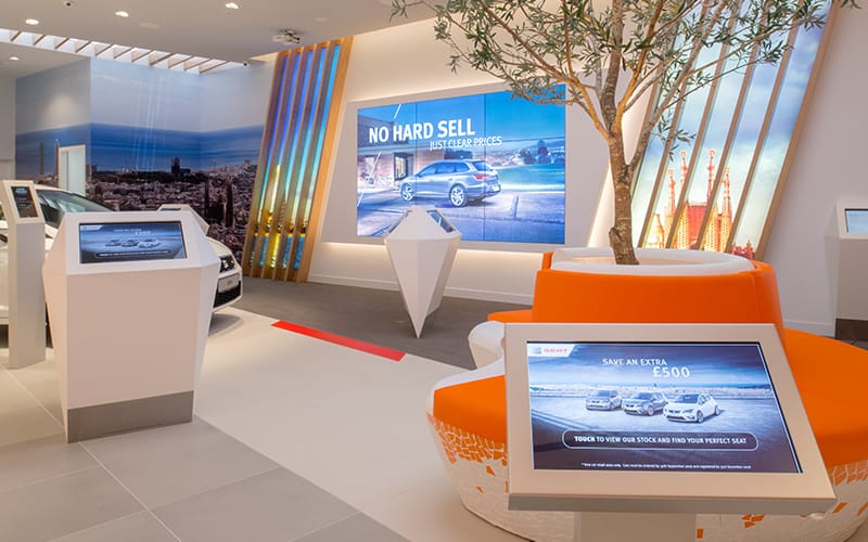 Multiple types of digital signage at a SEAT car showroom in the UK