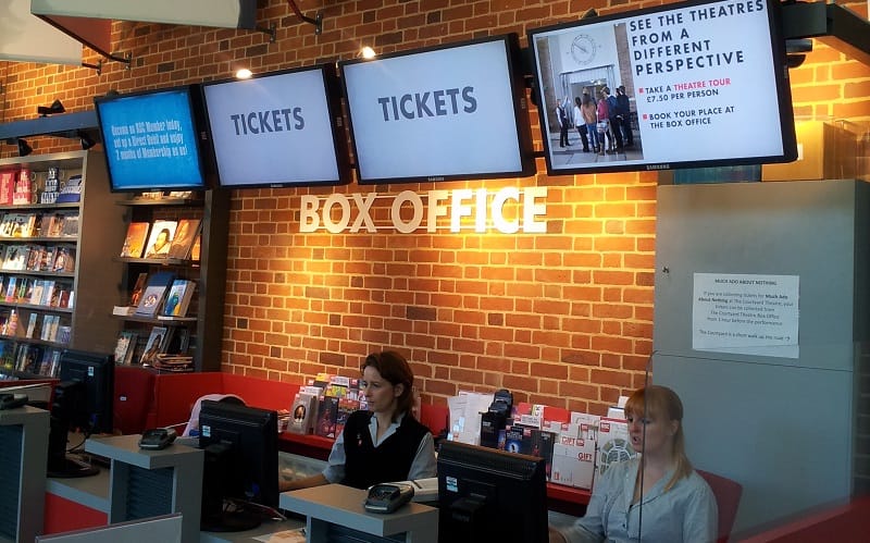 Digital signage screens in a theatre box office, advertising ticket offers