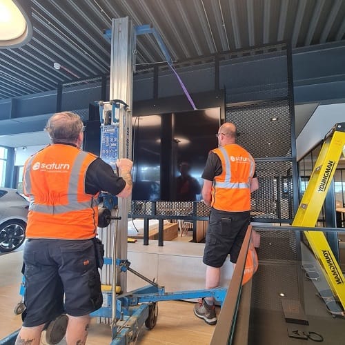 Digital signage being installed in a car showroom
