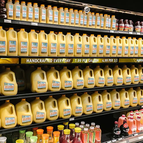 InstoreScreen shelf-edge digital signage displaying orange juice product prices