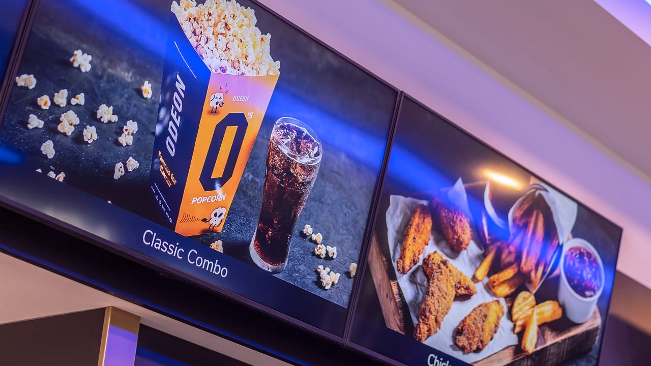 Digital menu boards in cinema, advertising food and drink offers.