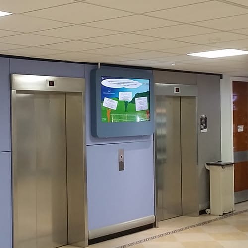 Digital signage screen in a lift lobby in a UK hospital