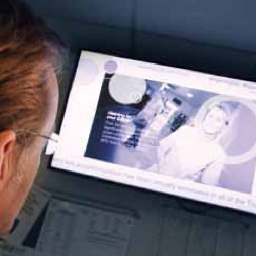 Man looking at digital signage screen in a hospital