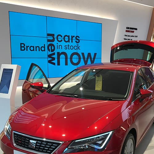 Video wall and pedestal digital signage in a car showroom