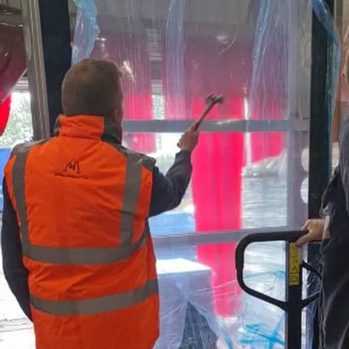 Using a hammer to test the robustness of the new bespoke bus shelter enclosure for Alight Media